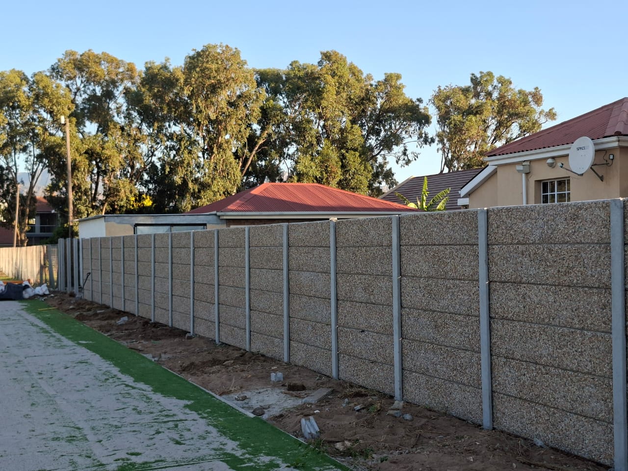 New 1.8m pebble-finish precast wall after a same-day replacement